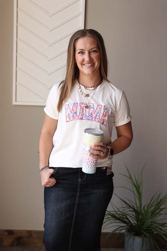 Treat yourself or a special mama friend to this cute and comfy "MAMA" tee! Featuring a stylish leopard multi color lettering, rolled sleeve cuffs, and a white fabric, this tee is perfect for any mom who loves to wear a trendy look while staying comfortable. Don't miss out on this must-have addition to your wardrobe! Classy Closet Hull Iowa