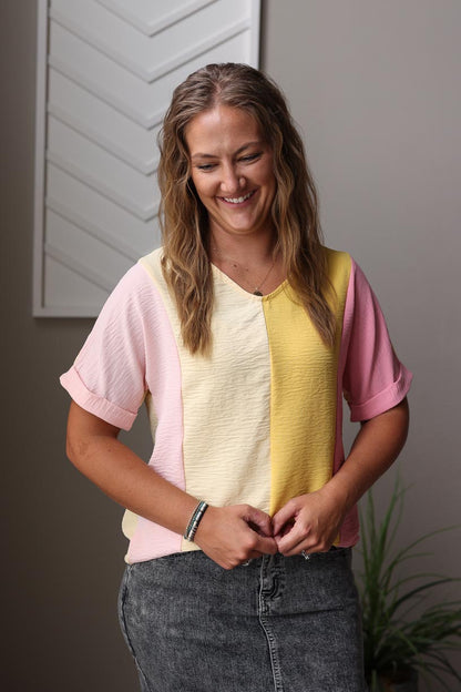 Step up your everyday look with our Apricot Crinkled Colorblock Top. Featuring vertical colorblock in fun light yellow, pink, and apricot colors, it's the perfect balance of chic and style. The soft and lightweight fabric, v-neck design, and rolled sleeve cuffs add a touch of playful detail to this versatile top. Perfect for work or brunch! Classy Closet online women's boutique for trendy modest clothing