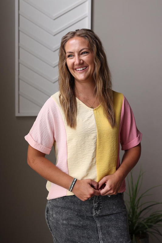 Step up your everyday look with our Apricot Crinkled Colorblock Top. Featuring vertical colorblock in fun light yellow, pink, and apricot colors, it's the perfect balance of chic and style. The soft and lightweight fabric, v-neck design, and rolled sleeve cuffs add a touch of playful detail to this versatile top. Perfect for work or brunch! Classy Closet online women's boutique for trendy modest clothing