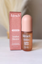 Kit-sch Amber Shores hair perfume bottle and packaging on a neutral background