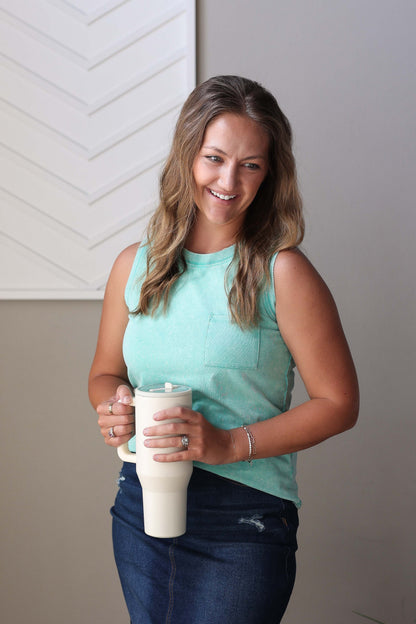 Enjoy the carefree vibes of summer with this Sea Green Mineral Wash Tank Top. Featuring a refreshing aqua sea green color, a comfortable crewneck, and wide sleeveless design, it offers a great fit with a straight cut hem. Made from a thicker fabric with a slight stretch, it feels high-quality and cozy—perfect to wear on its own without layering. Embrace easy, breezy style all season long!