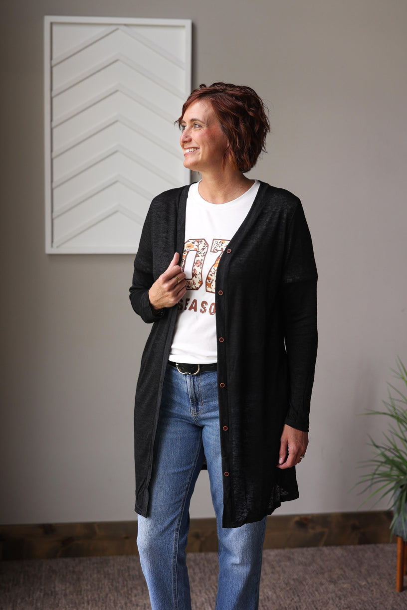 Stay cozy and stylish during season transitions with our versatile Black Button Cardigan, perfect for layering and everyday wear for fall winter outfits.