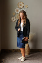 black fully lined blazer jacket with a dark wash denim skirt and sneakers