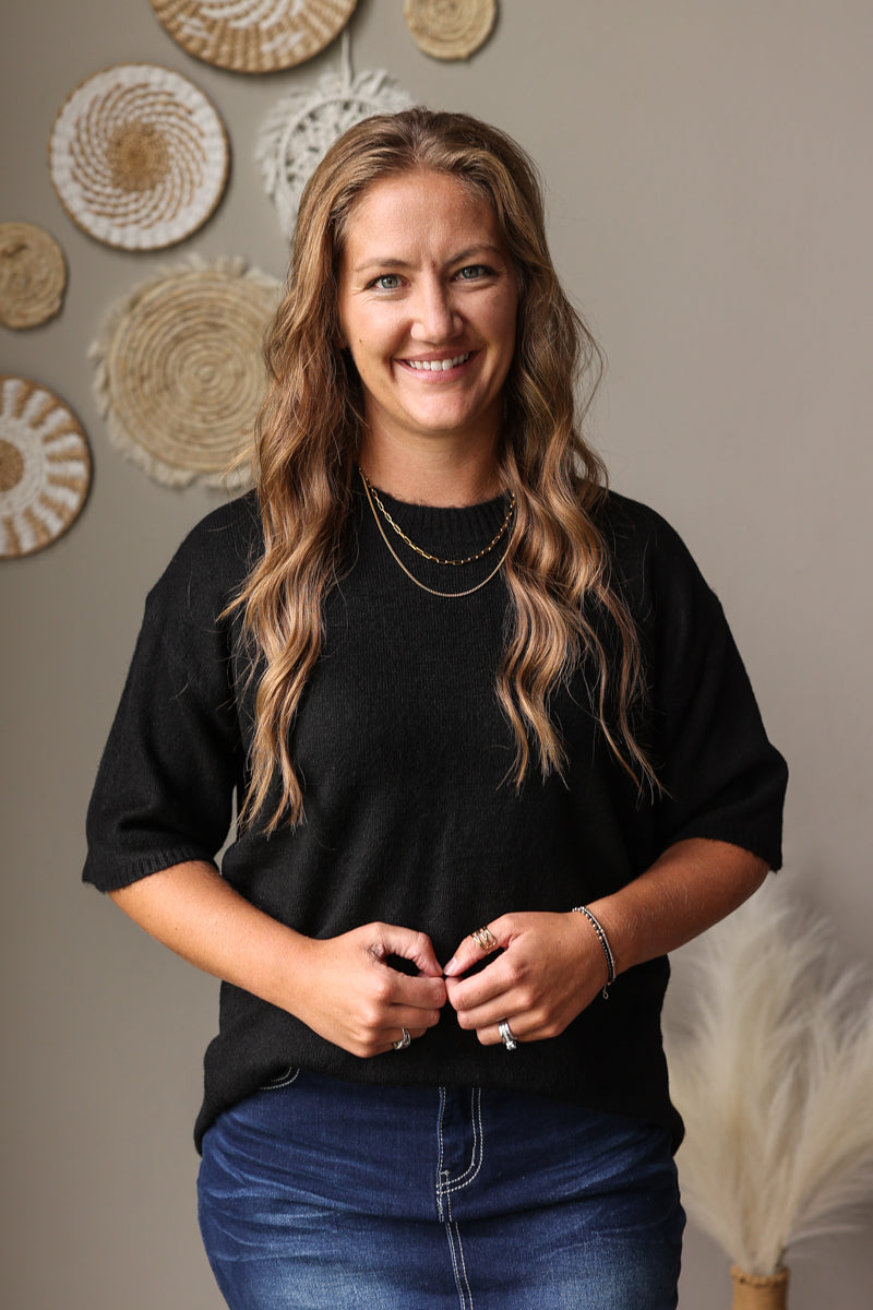 black half sleeve crew sweater with dark wash blue jean denim skirt
