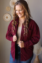 Wine corduroy shirt worn open, showing the collar, button front, and long sleeves.