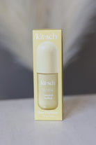 Kit-Sch Coastal Sorbet Hair Perfume in a pale yellow rectangular box with a matching bottle and cap, photographed against a soft gray and white blurred background.