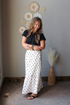off white black polka dot maxi skirt with side slits paired with a black button up gauze top