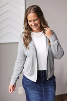 Stay cozy and stylish all day with the Grey Waffle Zip Up Hooded Jacket, perfect for busy moms looking to feel cute and put together effortlessly.