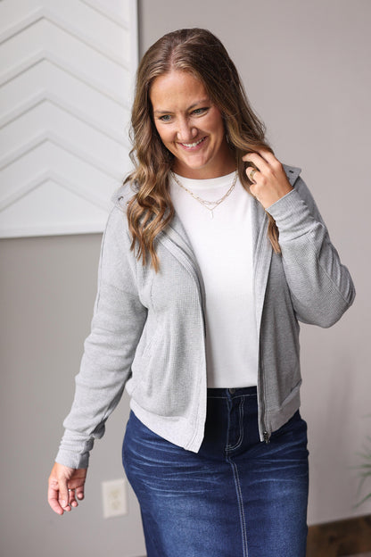 Stay cozy and stylish all day with the Grey Waffle Zip Up Hooded Jacket, perfect for busy moms looking to feel cute and put together effortlessly.