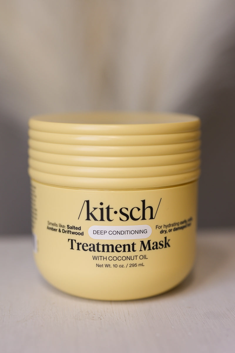 A pale yellow jar of kit-sch Treatment Mask with Coconut Oil, shown on a neutral gray background.