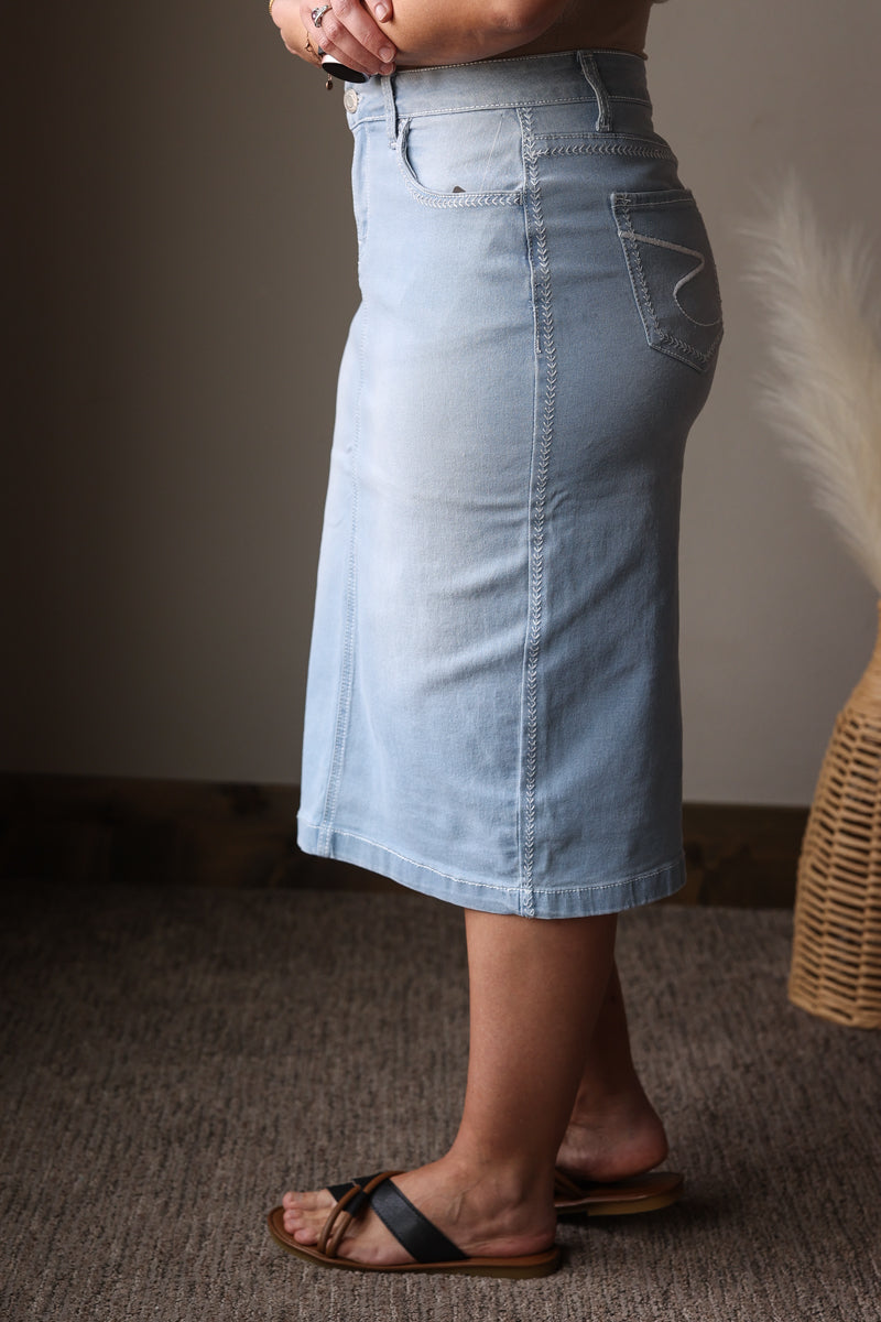Light blue denim skirt worn by a person on a neutral background