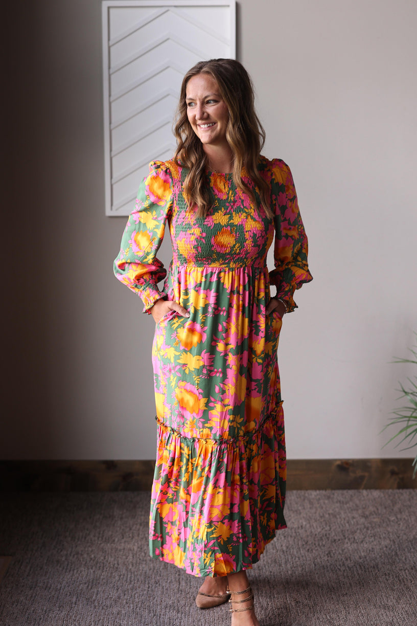 "Fall" in style with our Orange Floral Smocked Maxi Dress featuring vibrant colors and comfortable details perfect for any occasion.