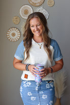 grey short sleeve top with denim short sleeve and hem band details with daisy floral midi denim skirt outfit