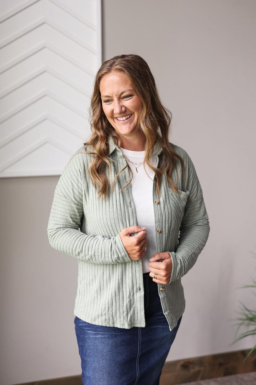The Mist Green Textured Button Up Shirt features a ribbed texture that feels super soft and mid-lightweight, making it an easy layer with a great fit—true to size, as shown on a typical small wearing the small.