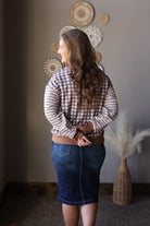Back view of a brown and cream gingham top styled with a dark denim skirt.