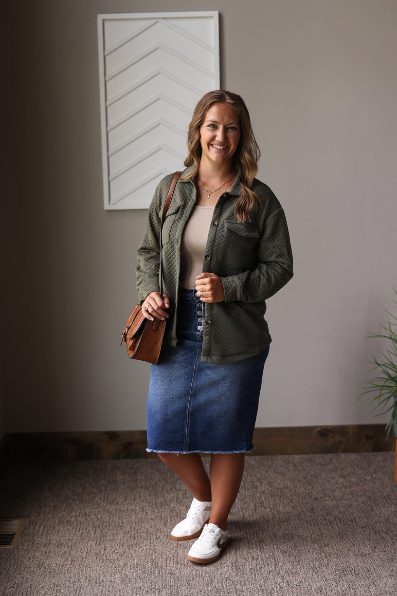 green quilted shacket over a tan tank top and denim skirt with white brown sneakers for a cute easy mom fall outfits
