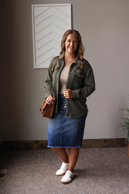 green quilted shacket over a tan tank top and denim skirt with white brown sneakers for a cute easy mom fall outfits