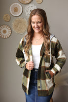 green white brown toned fleece button up shacket with a hood and side pockets styled over a white top with a dark wash midi denim skirt