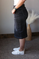 black wash denim skirt on a woman