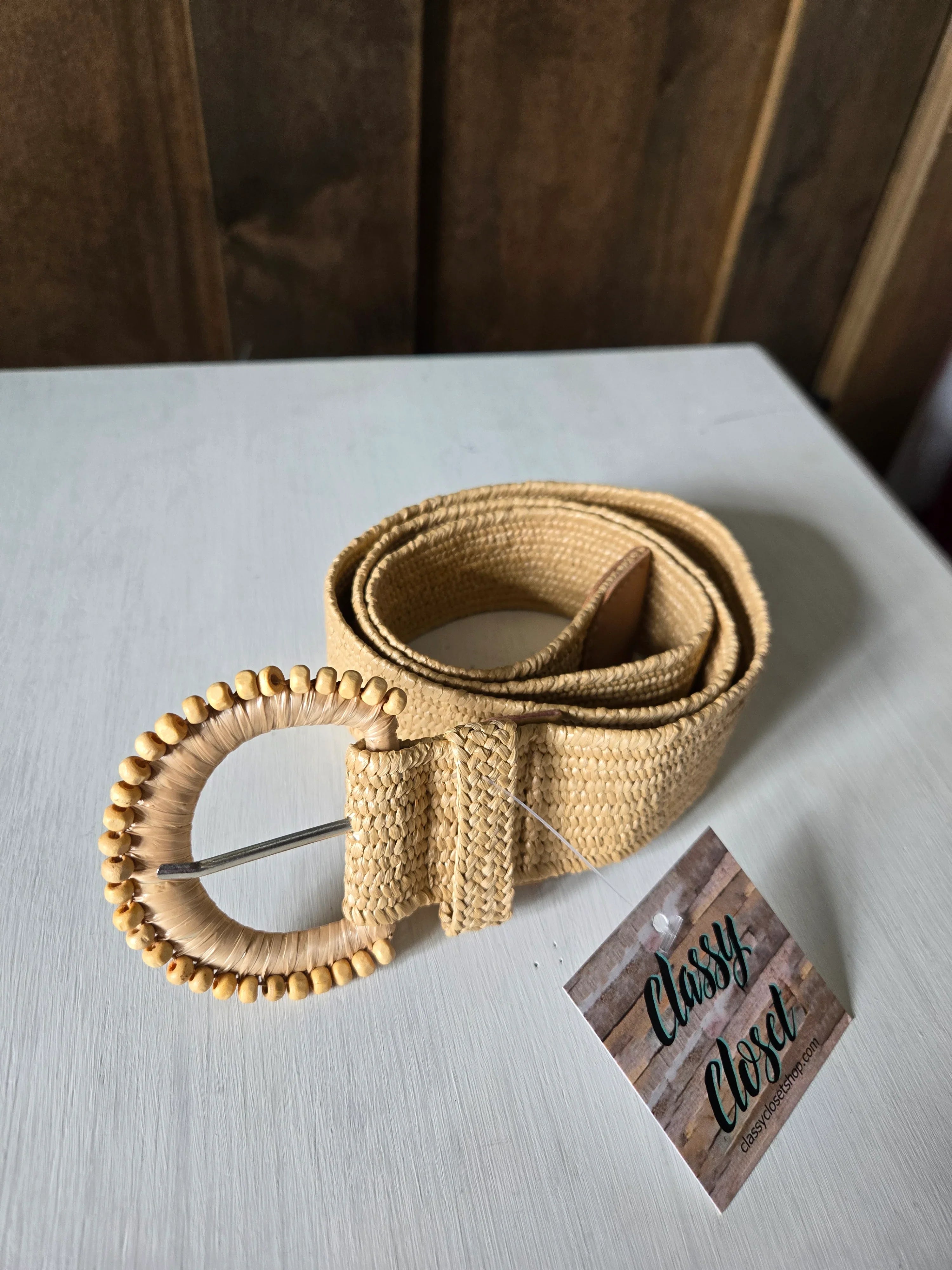 Beige belt with decorative elements on a light gray surface