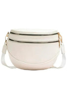 White crossbody bag with gold zippers on a white background