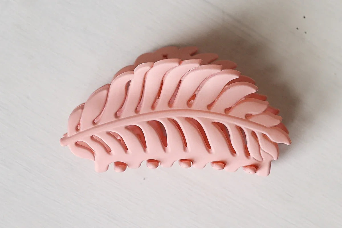 Pink leaf-shaped object on a white background