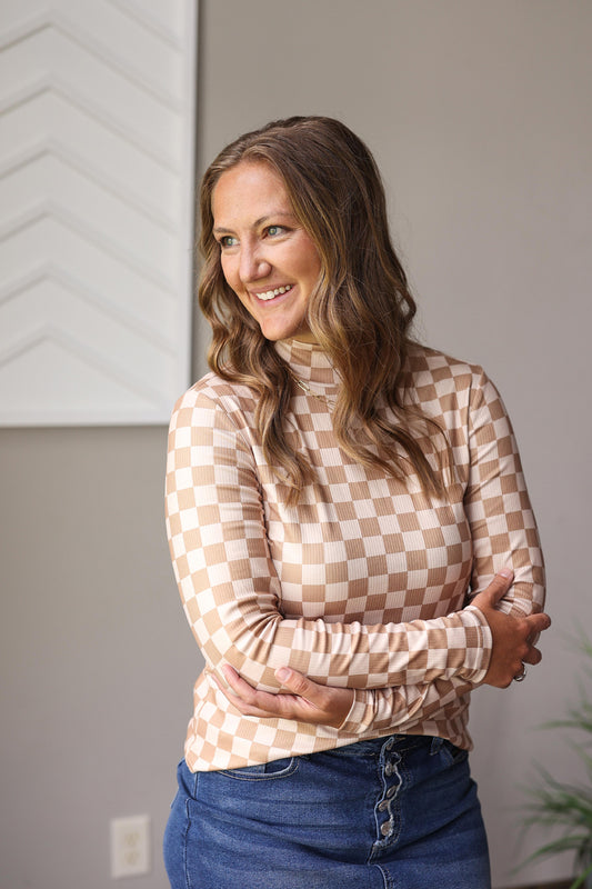 Stay effortlessly stylish and cozy with our Khaki Check Pattern Turtleneck Ribbed Top, perfect for casual or smart looks all day long.