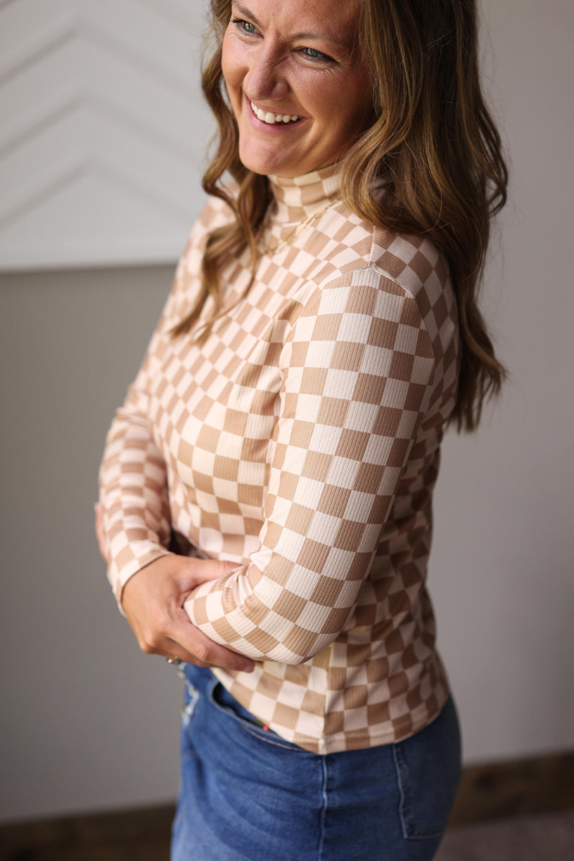 Woman wearing a checkered blouse and blue jeans denim skirt for a cute and easy fall mom outfits