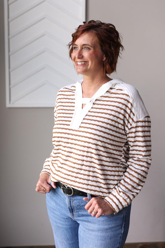 effortlessly stylish and cozy in the Khaki Stripe Textured Hooded V-Neck Top, perfect for casual outings like grabbing coffee with the girls, casual Friday at the office, or simply relaxing at home.