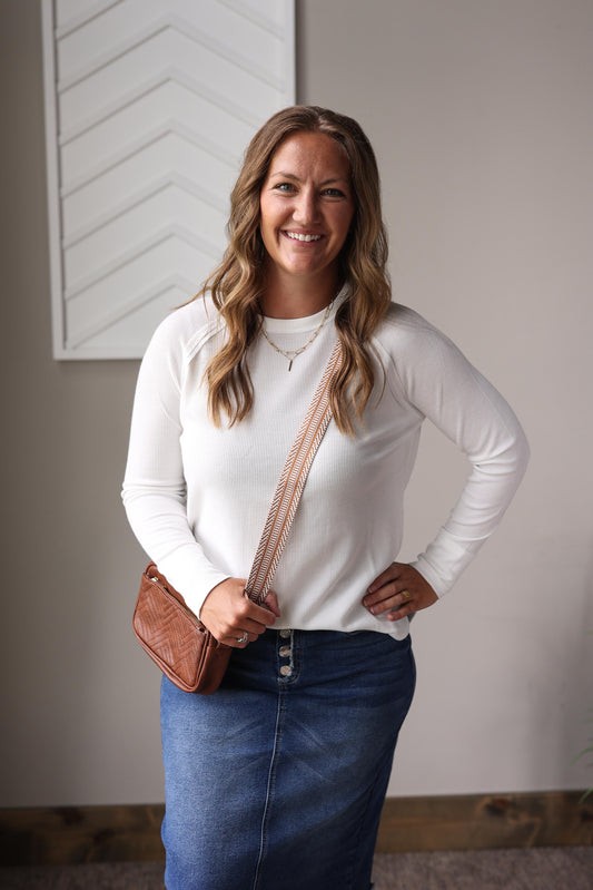 White waffle knit crew long sleeve top layered under denim jacket with plaid midi skirt.